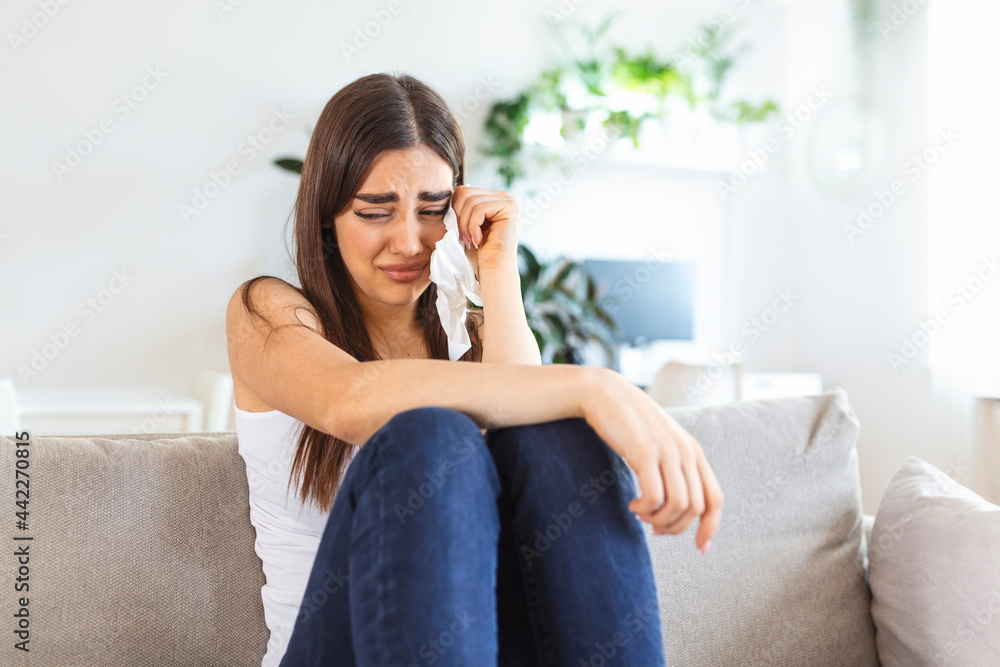 Unhappy young woman covering face with hands, crying alone close up, depressed girl sitting on couch at home, health problem or thinking about bad relationships, break up with boyfriend, divorce Unhappy young woman covering face with hands, crying alone close up, depressed girl sitting on couch at home, health problem or thinking about bad relationships, break up with boyfriend, divorce