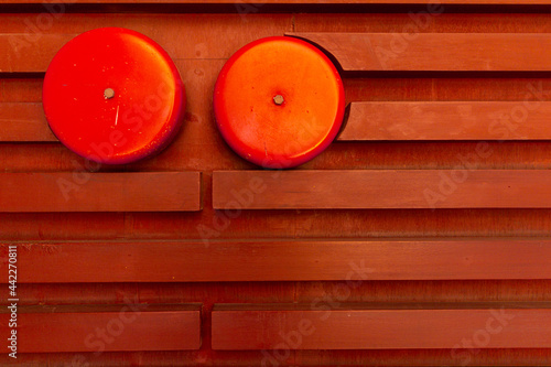 Close up the alarm on  red wooden  wall background