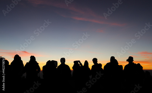 Silhouette scenery of group of people in morning dawn. 