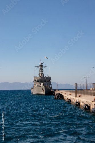 Canvastavla A Hellenic Navy patrol fighter in the port of Rhodes against blue skies