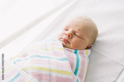 sleeping newborn in hospital blanket