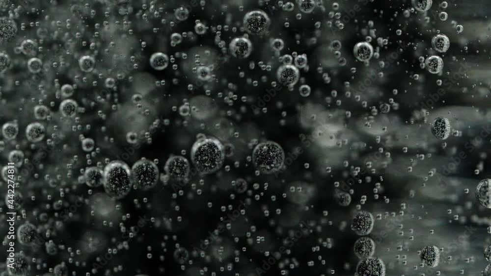 Slow motion closeup abstract water bubbles on black background, macro soda drink Slow motion closeup abstract water bubbles on black background, macro soda drink