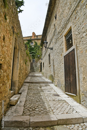Fototapeta Naklejka Na Ścianę i Meble -  A narrow street among the old houses of Bovino, a medieval village in the Puglia region.