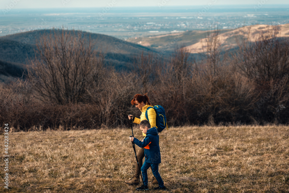 Mother and son hiking together in the mountains.