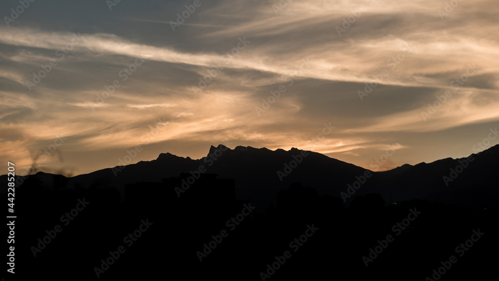 Fototapeta premium Cloudy sunset over mountains
