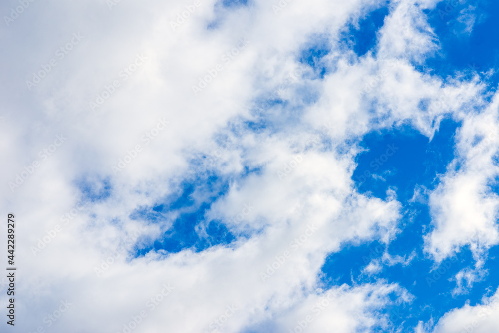 Fototapeta premium Dramatic blue sky with white clouds background.
