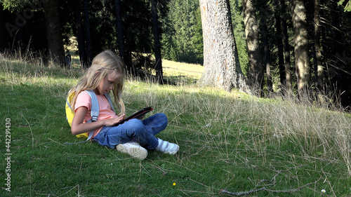 Kid Playing Tablet on Meadow in Camping in Mountains, Child Use Smartphones in Forest, Girl Plays on Device Outdoor in Park