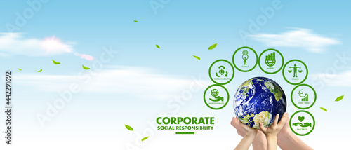 Corporate social responsibility (CSR) concept. Hands holding earth globe over sky background. Sustainable development goals (SDGs) concept: adult and child hands holding globe with environmental icons