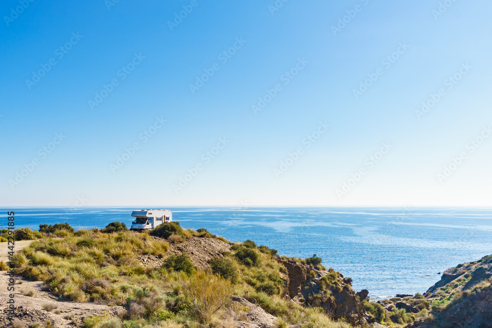 Camper on cliff, coast in Spain