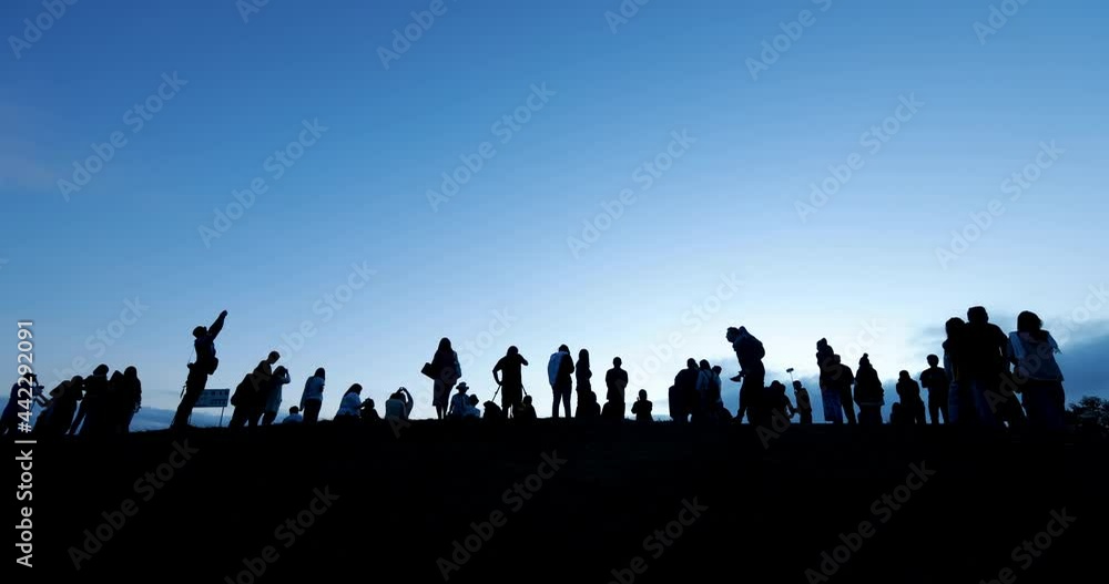Silhouettes of tourist crowd waiting for the sunrise and doing activity, taking a photo, selfie with nature on the hill at viewpoint. Silhouettes of tourist crowd waiting for the sunrise and doing activity, taking a photo, selfie with nature on the hill at viewpoint.