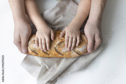 Top view of bread in the hands of father and son