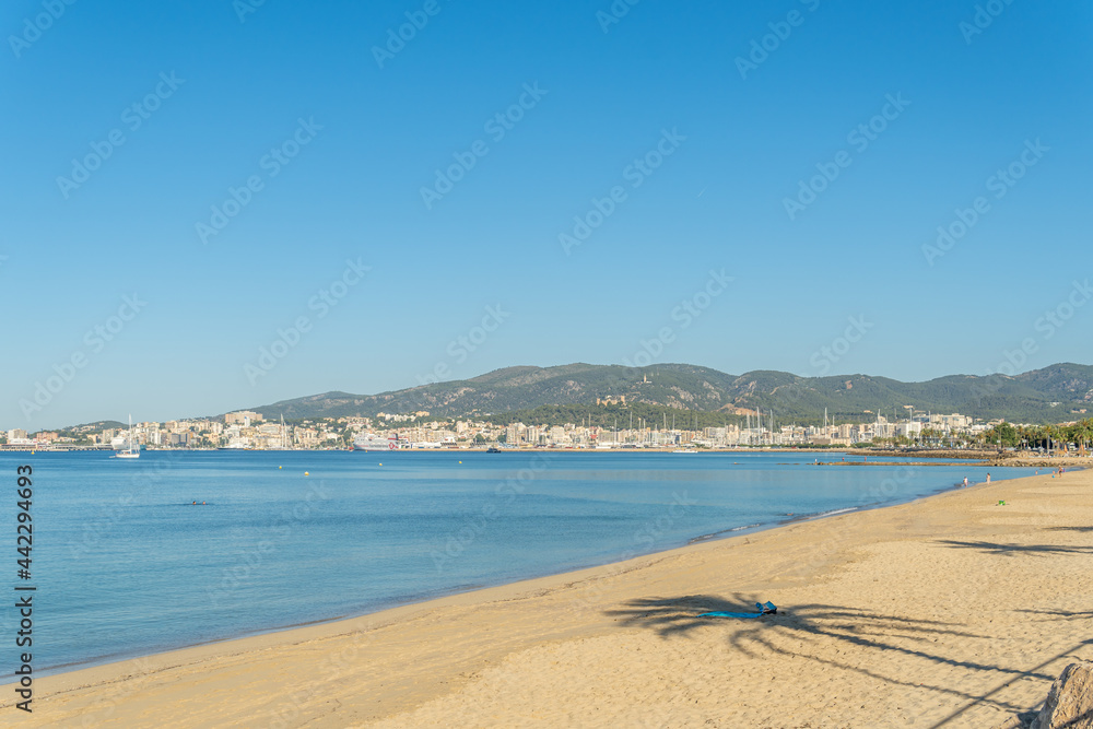 General view of Can Pere Antoni beach with the city of Palma de Mallorca in the background at sunrise