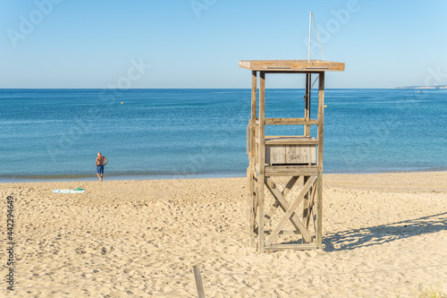 General view of Can Pere Antoni beach at sunrise. Wooden lifeguard tower in the foreground photo