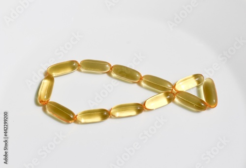 Capsules of omega 3 in the shape of a fish. Cod liver fish oil
