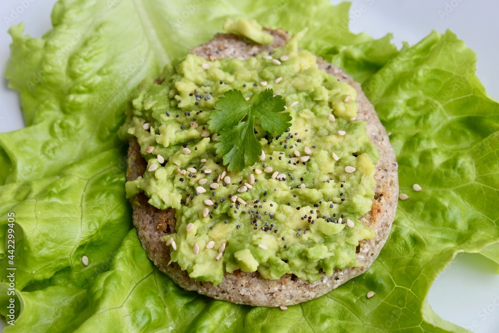 Boiled egg with black seeds on avocado toast made of buckwheat Boiled egg with black seeds on avocado toast made of buckwheat