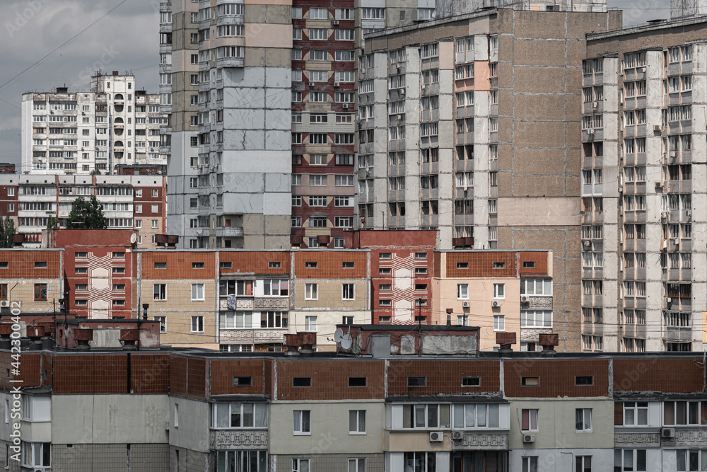Cityscape of a stuffy post-Soviet city, densely built up with multi-storey residential panel buildings in red and white colors. Cityscape of a stuffy post-Soviet city, densely built up with multi-storey residential panel buildings in red and white colors.