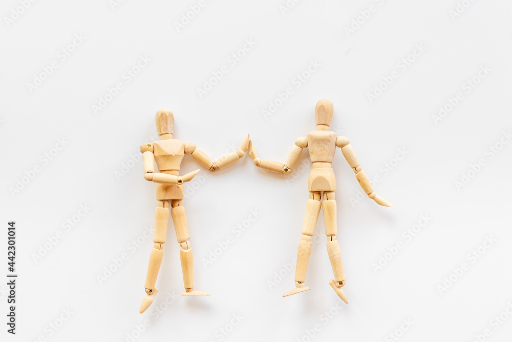 Two wooden figure connection - emotional communication concept Two wooden figure connection - emotional communication concept