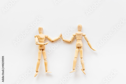 Two wooden figure connection - emotional communication concept