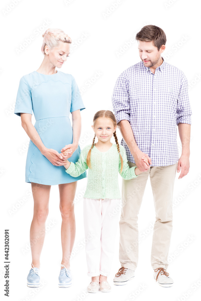 Vertical full length isolated shot of modern family with one little daughter standing together holding hands, white background Vertical full length isolated shot of modern family with one little daughter standing together holding hands, white background
