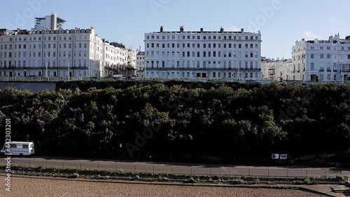 Aerial video from Madeira drive with beautiful Victorian buildings along the seafront and Brighton Royal Sussex County Hospital in the background. photo