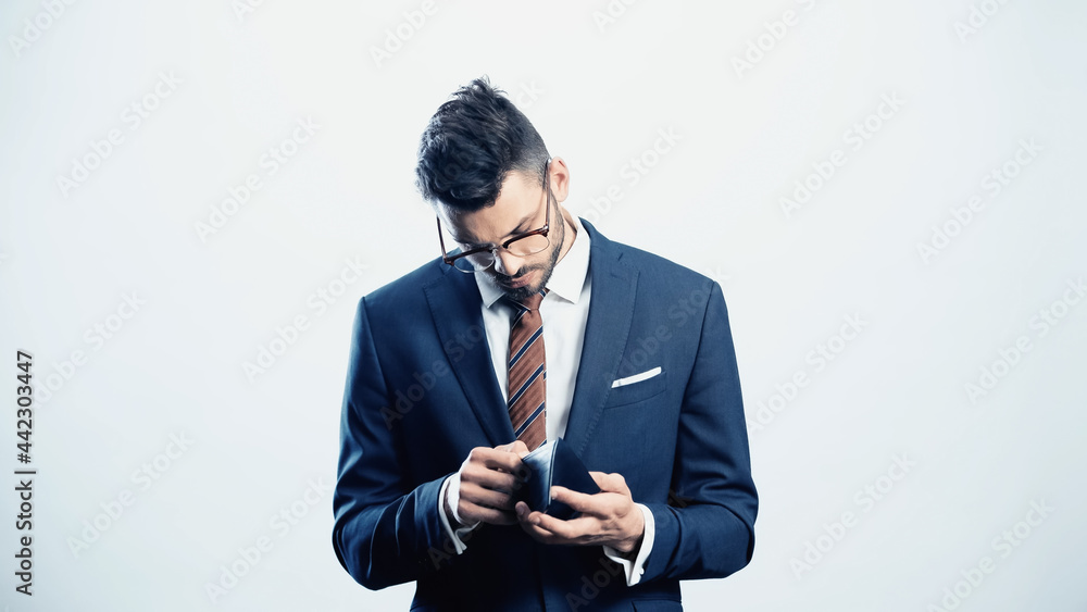 young businessman looking into wallet isolated on white young businessman looking into wallet isolated on white