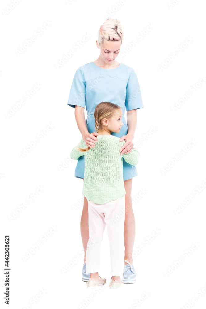 Vertical full length isolated shot of cute little girl with two braids hugging her loving mother, white background Vertical full length isolated shot of cute little girl with two braids hugging her loving mother, white background
