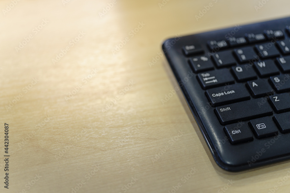Closeup of black computer keyboard on wooden table with copy space. Closeup of black computer keyboard on wooden table with copy space.