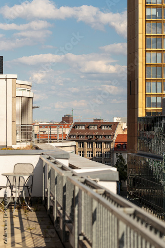 View of varied buildings with different architectural styles in the Berlin Mitte district, from high a terrace. Horizontal cityscape from a high view balcony during sunny day with blue sky and clouds