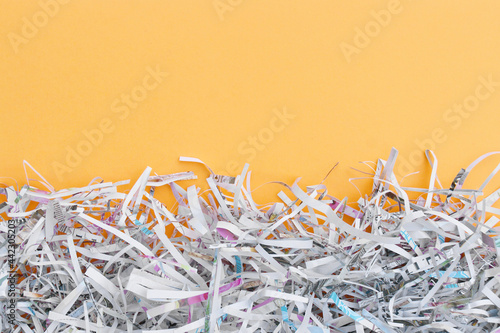 The shredded paper on light orange background.