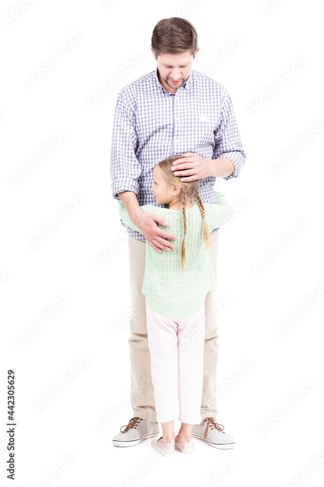 Vertical full length isolated shot of beautiful little girl with two braids hairstyle hugging her loving father, white background Vertical full length isolated shot of beautiful little girl with two braids hairstyle hugging her loving father, white background