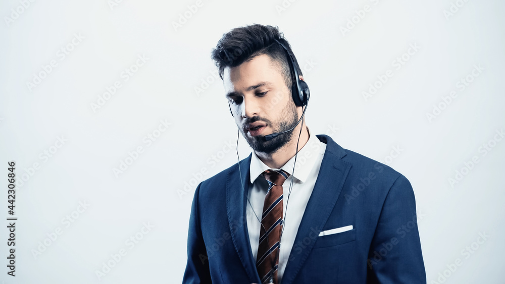 serious call center operator in headset talking isolated on white serious call center operator in headset talking isolated on white