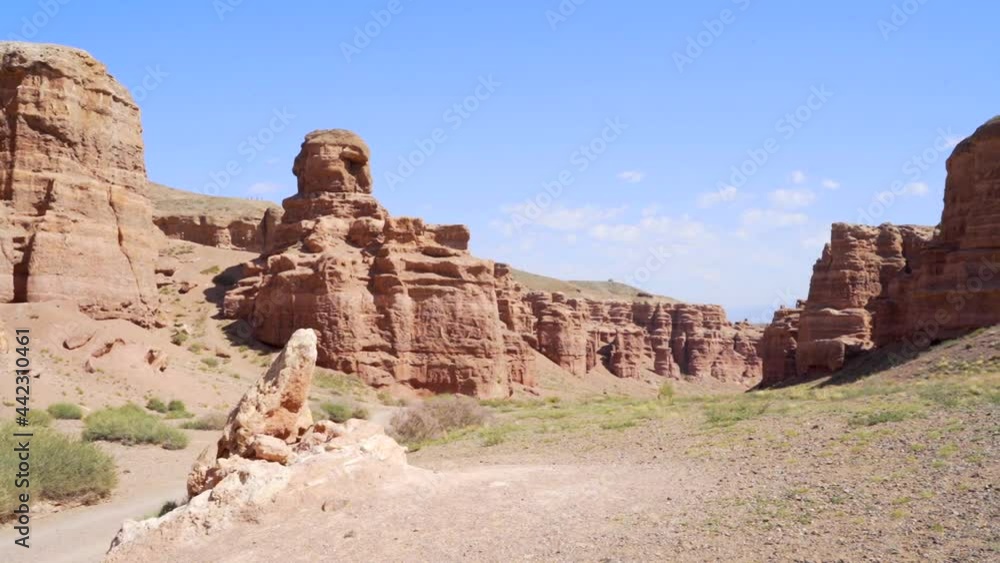 Fantastic view. Unusual landscape. Winding road located inside the ancient canyon Charyn. Grand canyon Charyn. sedimentary rocks. Huge cracks in the rocks. The ground is red-orange. Fantastic view. Unusual landscape. Winding road located inside the ancient canyon Charyn. Grand canyon Charyn. sedimentary rocks. Huge cracks in the rocks. The ground is red-orange.