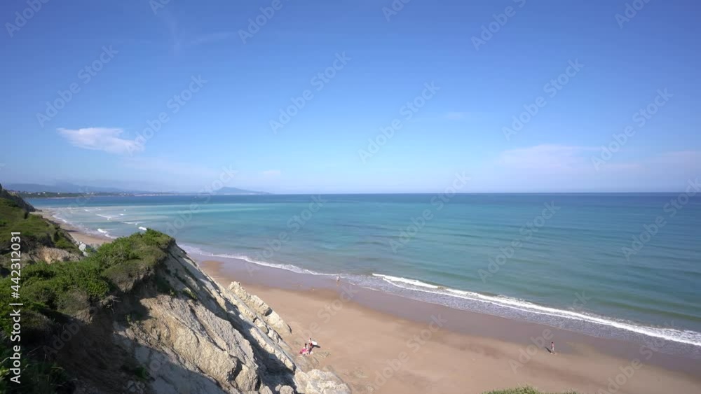 Coast of Plage des 100 marches popular surfing and nudist beach in western France with surfers walking below, Aerial dolly out shot Coast of Plage des 100 marches popular surfing and nudist beach in western France with surfers walking below, Aerial dolly out shot