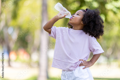 Concept of childhood and drinking water on a hot day.