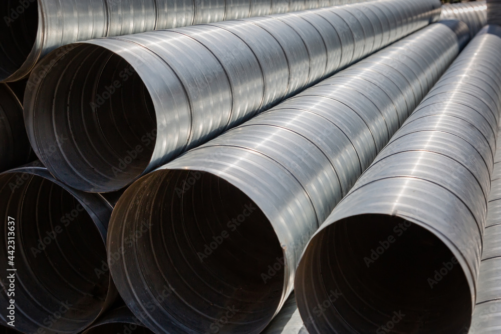 Ventilation pipe warehouse. Steel pipes, parts for the construction of air ducts for an industrial air conditioning system in a warehouse. Industrial airway ventilation equipment and piping systems Ventilation pipe warehouse. Steel pipes, parts for the construction of air ducts for an industrial air conditioning system in a warehouse. Industrial airway ventilation equipment and piping systems