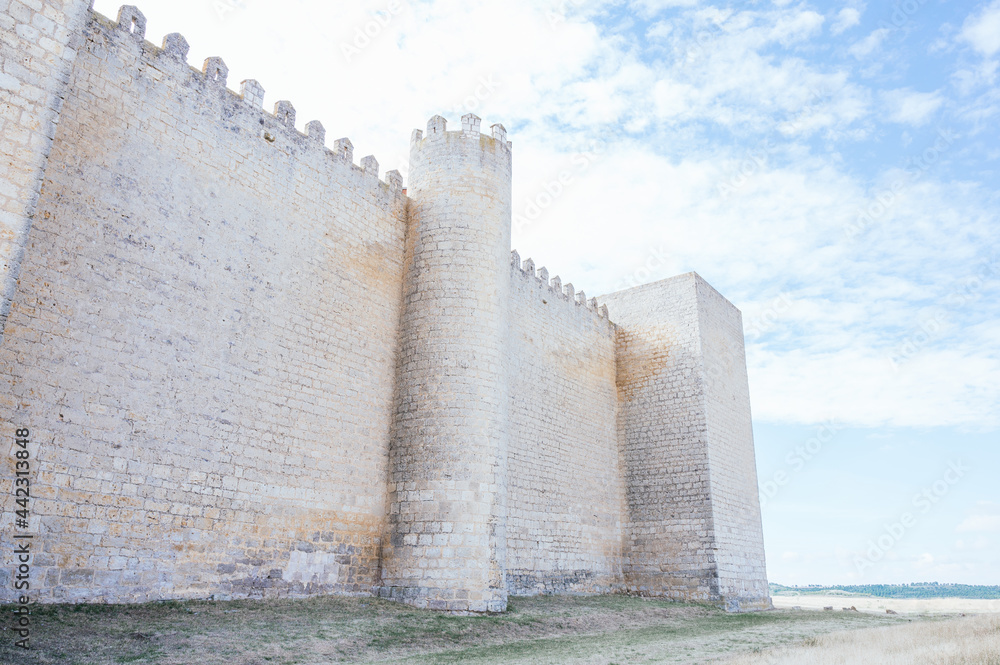 Facade of a 13th century castle in the morning under a blue sky with clouds Facade of a 13th century castle in the morning under a blue sky with clouds