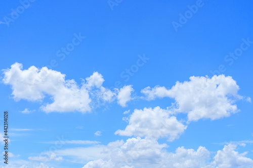 The sky is bright blue with beautiful fluffy clouds.