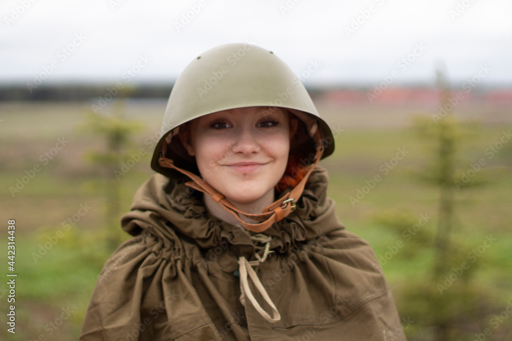 The girl in a military helmet. A woman in the uniform of a soldier of the Second World War. The girl in a military helmet. A woman in the uniform of a soldier of the Second World War.