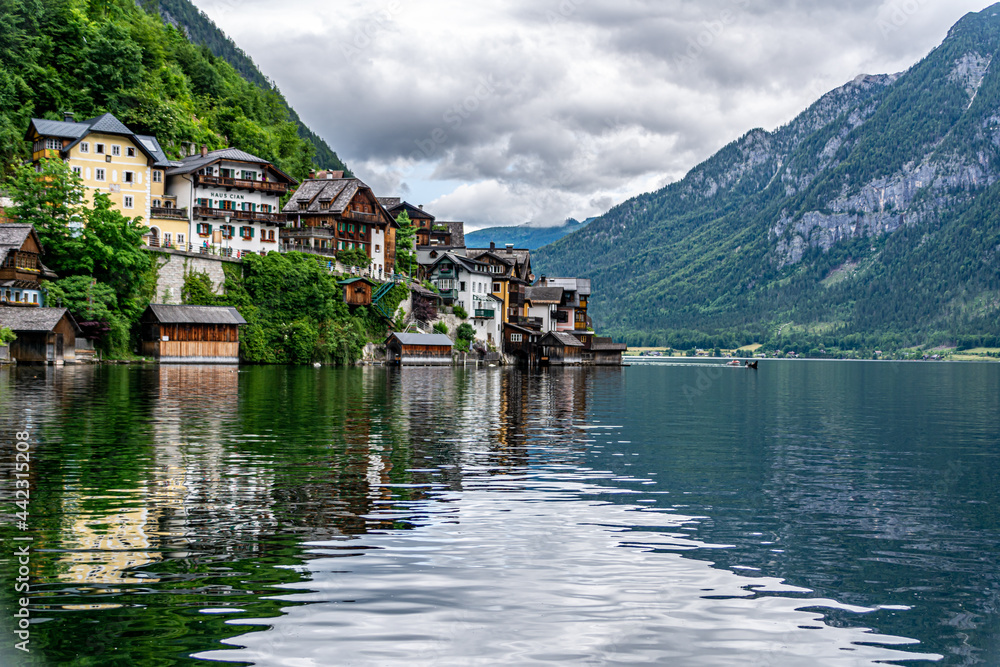 View of traditional houses in Hallstatt, Austria. Reflections in the Lake on a summer day with overcast