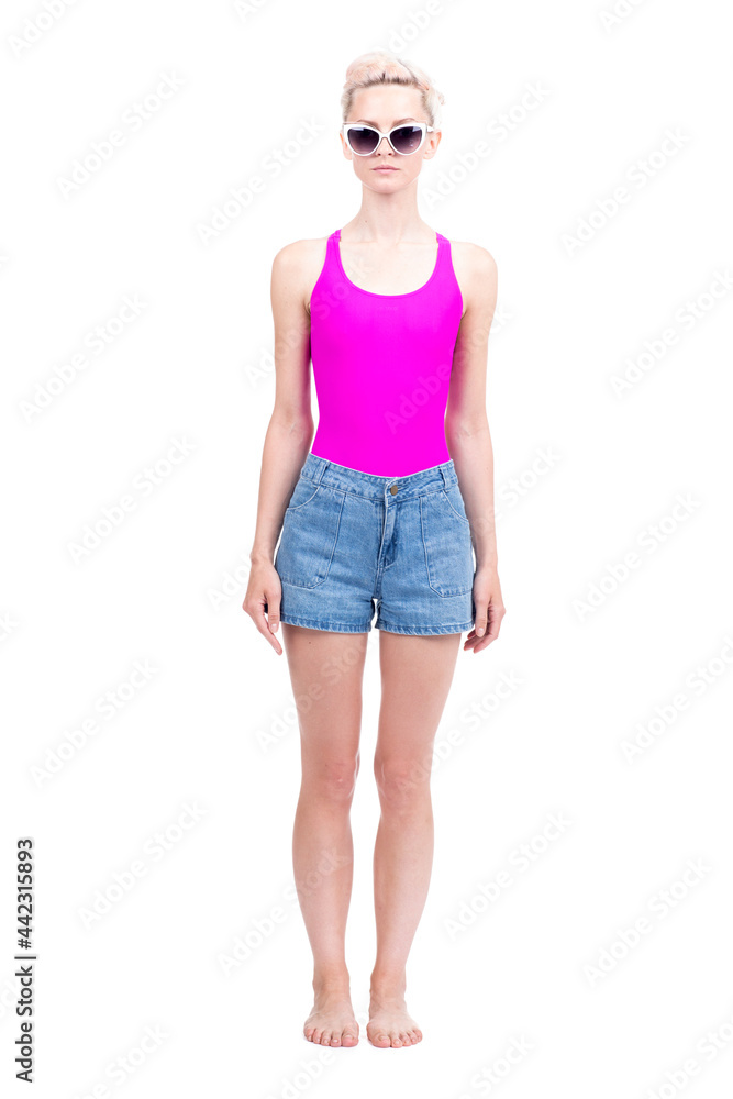 Vertical full length studio portrait of beautiful young Caucasian woman wearing summer outfit posing on camera, white background Vertical full length studio portrait of beautiful young Caucasian woman wearing summer outfit posing on camera, white background