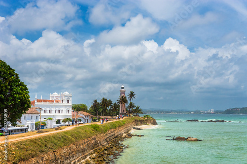White lighthouse and Meeran Jumma Masjid mosque in old Dutch Galle fort, Sri Lanka in sunny day