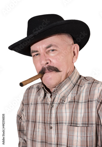 The cowboy with mustache, in a black hat smoking a cigar