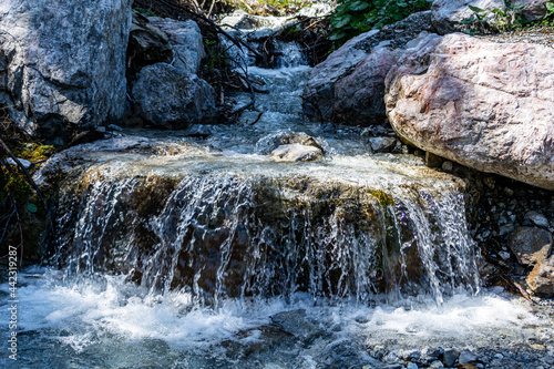 Obraz na płótnie Small alpine waterfall in Salzburg, Austria. Fresh, crystal clear water on a warm summer day w salonie