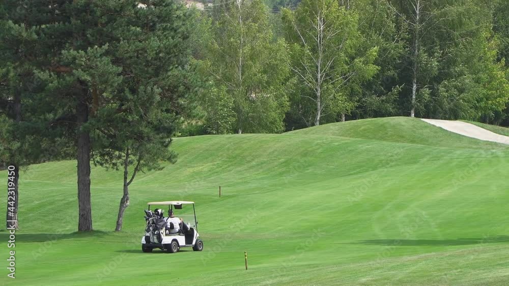 Bansko, Bulgaria - 12 Sep, 2019: Couple in buggy in golf course Bansko, Bulgaria - 12 Sep, 2019: Couple in buggy in golf course