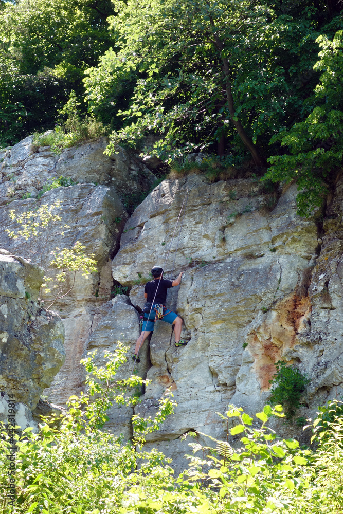 A climber climbs a travertine wall in Dreveník Slovakia