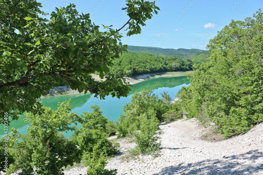 Novoulyanovskoe reservoir, Bakhchisarai district, Crimea, Russia, top view - emerald lovely lake in the mountains. Novoulyanovskoe reservoir, Bakhchisarai district, Crimea, Russia, top view - emerald lovely lake in the mountains.