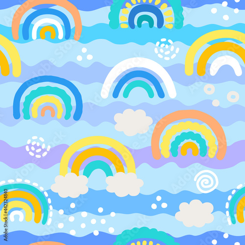 Seamless pattern with hand drawn rainbows and clouds in pastel colors. Childish print for nursery in a Scandinavian style. Ideal for baby clothes, textiles, wallpaper, packaging.  