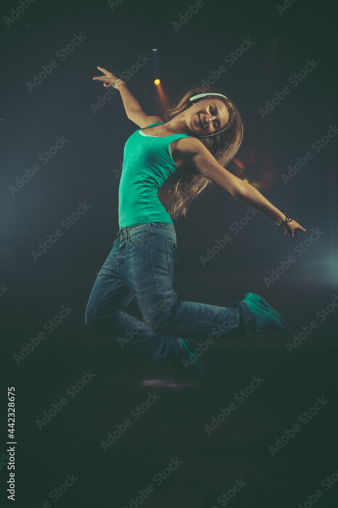 Dynamic animated young woman jumping with headphones