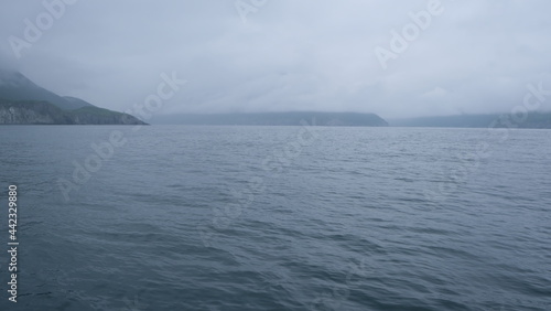 hills and mountains in big water on a gray day in the pacific ocean