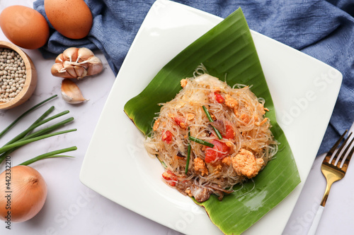 Stir fried vermicelli with egg and vegetables with some ingredient on white background - Thai food called Pad Woonsen at top view photo